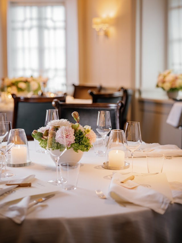 A round table set with candles and low florals
