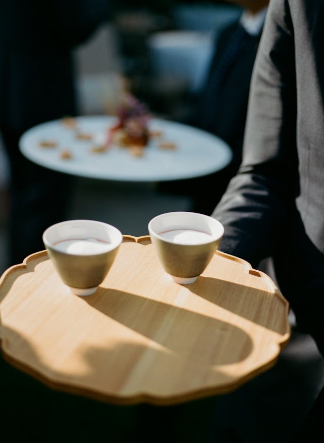 Warm cups passed on a carved tray