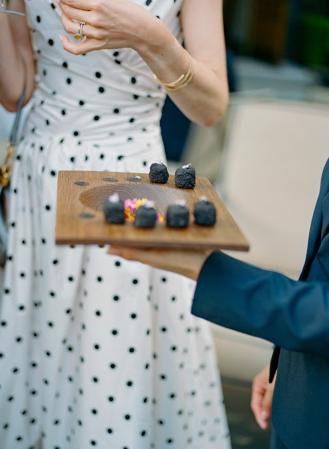 Black sesame bites passed on a wooden board