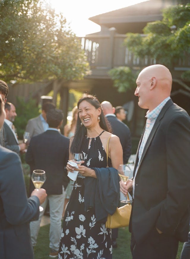 Guests in conversation at sunset