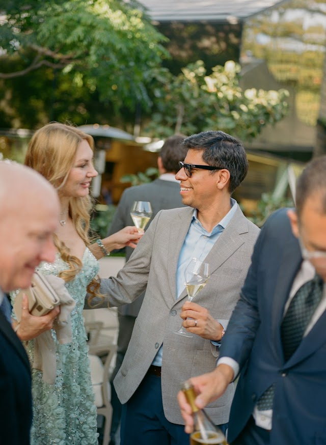Guests toasting near the roses