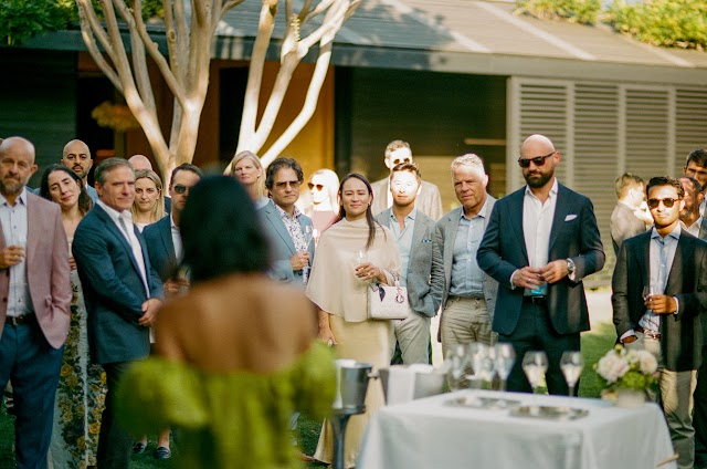 Guests listening across the lawn