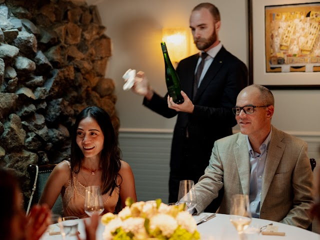 A sommelier presenting a bottle to the table